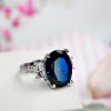 Oval Created Sapphire Three Stone Engagement Ring in Sterling Silver