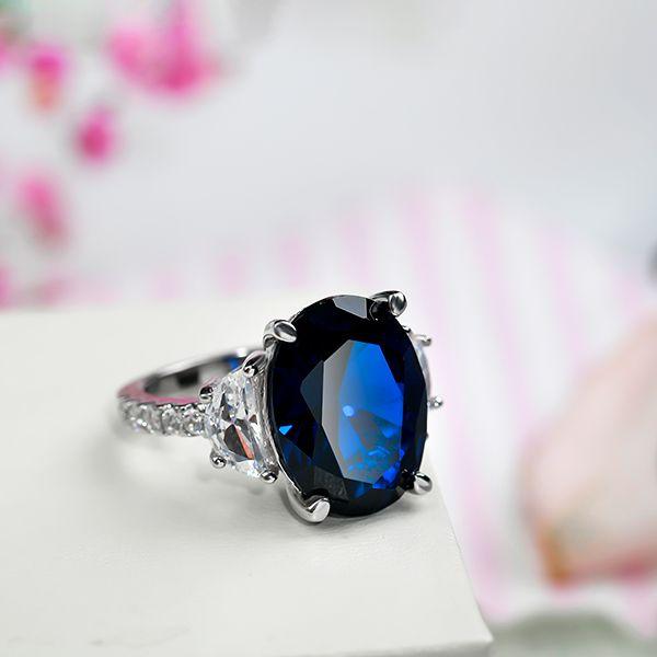 Oval Created Sapphire Three Stone Engagement Ring in Sterling Silver