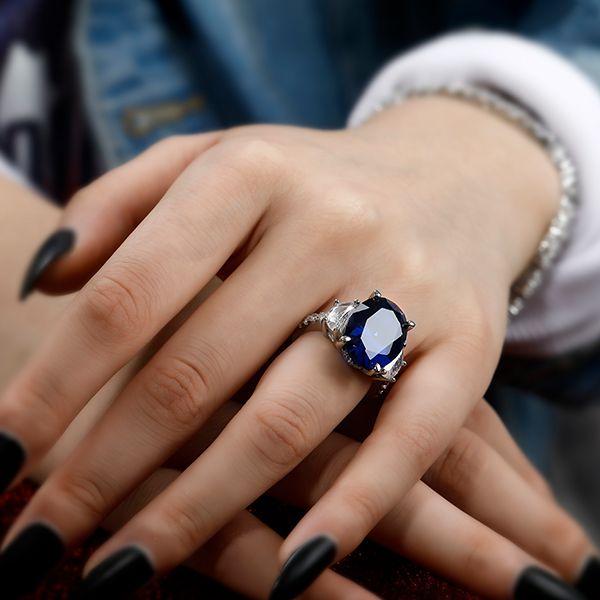 Oval Created Sapphire Three Stone Engagement Ring in Sterling Silver