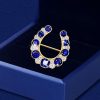 Golden Horseshoe Brooch with Blue Sapphire - Vintage Style
