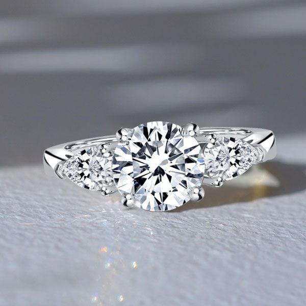 Three Stone Engagement Ring Pear Cut Center with Round Accents in Rhodium Plated Sterling Silver