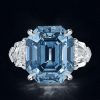 Three Stone Emerald Cut Blue Topaz Engagement Ring in Rhodium Plated Sterling Silver