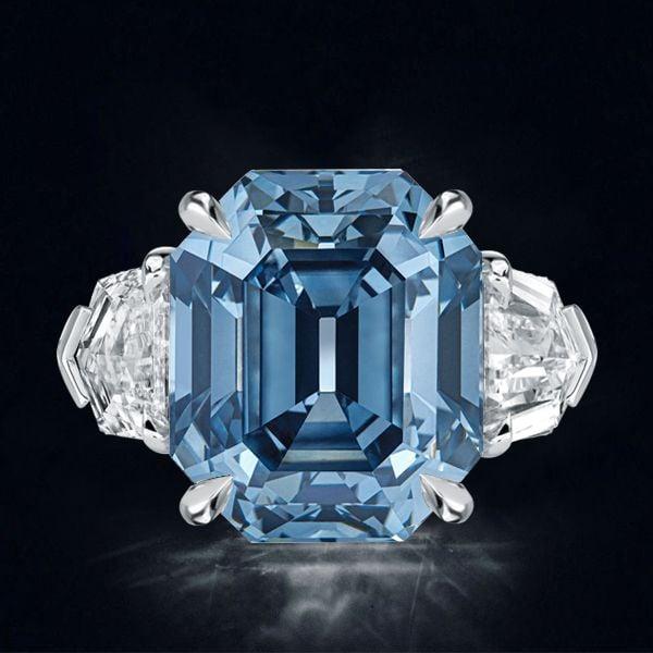 Three Stone Emerald Cut Blue Topaz Engagement Ring in Rhodium Plated Sterling Silver
