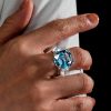 Three Stone Emerald Cut Blue Topaz Engagement Ring in Rhodium Plated Sterling Silver