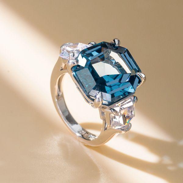Three Stone Emerald Cut Blue Topaz Engagement Ring in Rhodium Plated Sterling Silver