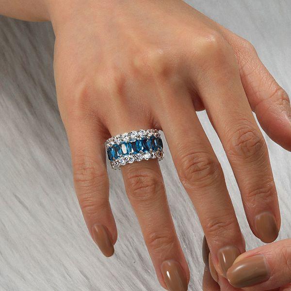 Emerald Cut Created Blue Topaz Eternity Wedding Band in Sterling Silver