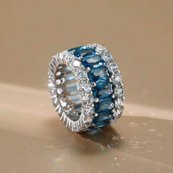 Emerald Cut Created Blue Topaz Eternity Wedding Band in Sterling Silver