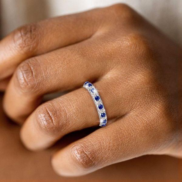 Round Cut White and Blue Sapphire Eternity Band Ring in Rhodium Plated Sterling Silver