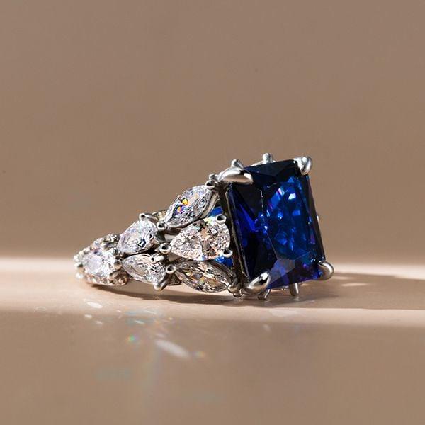 10.99 CTW Radiant and Pear Cut Blue Sapphire Engagement Ring in Rhodium Plated Sterling Silver