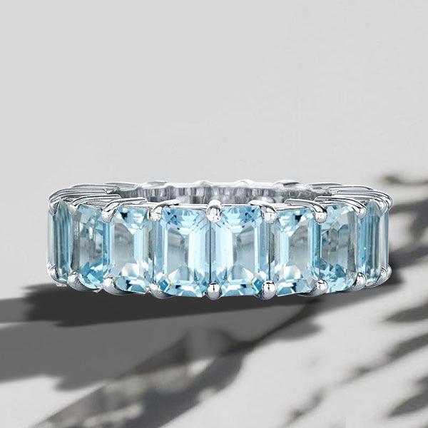 8.50 CT. TW. Emerald Cut Aquamarine Eternity Band Ring in Rhodium Plated Sterling Silver