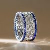 Round Cut White & Blue Sapphire Wedding Band in 925 Sterling Silver
