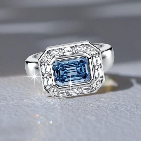 East West Emerald Cut Blue Topaz Engagement Ring in Sterling Silver