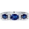 Oval Blue Sapphire Half Eternity Wedding Band in Rhodium-Plated Sterling Silver