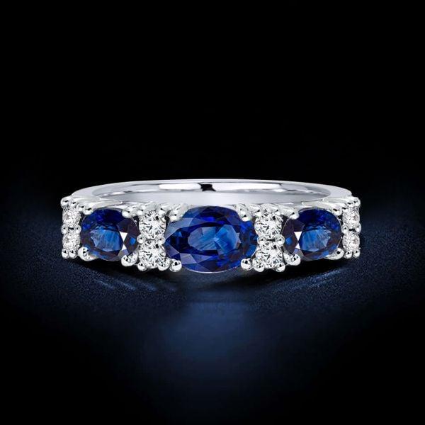 Oval Blue Sapphire Half Eternity Wedding Band in Rhodium-Plated Sterling Silver