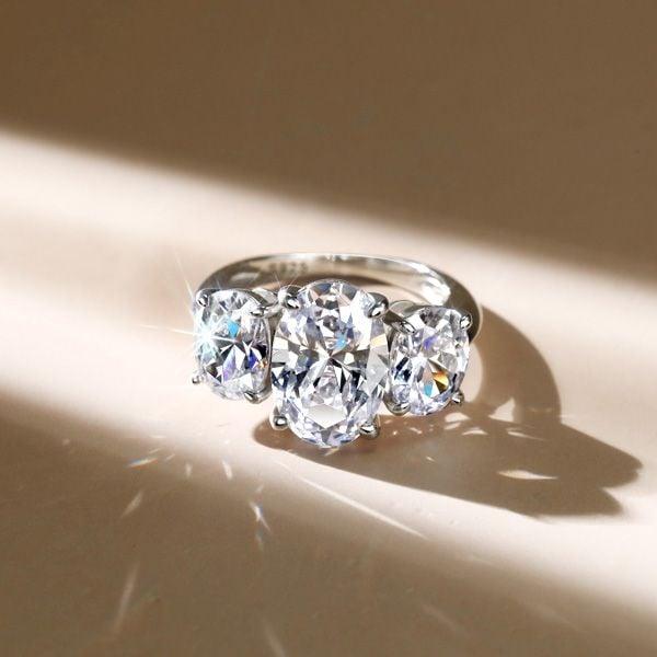 Three Stone Oval Created White Sapphire Engagement Ring in Rhodium Plated Sterling Silver