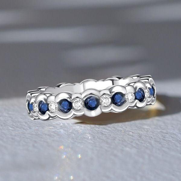 Channel Set White and Blue Sapphire Eternity Band Ring in Sterling Silver