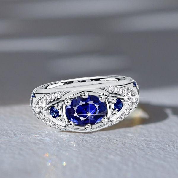 Oval Cut Blue Sapphire Halo Engagement Ring in Rhodium Plated Sterling Silver