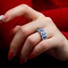 Created Sapphire Round and Oval Halo Wedding Band in Rhodium Plated Sterling Silver