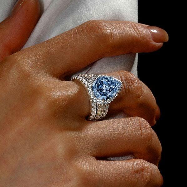 Pear Cut Blue Topaz Engagement Ring Set in Rhodium Plated Sterling Silver