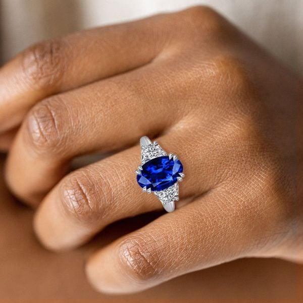 Three Stone Oval Cut Blue Sapphire Engagement Ring in Sterling Silver