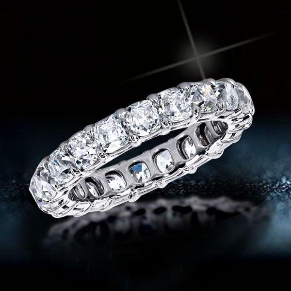 Created White Sapphire Cushion Cut Eternity Wedding Band in Rhodium-Plated Sterling Silver