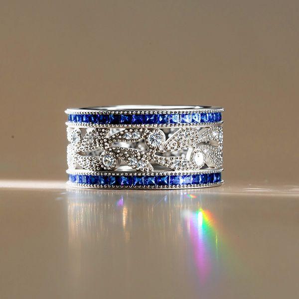 Round Cut White & Blue Sapphire Wedding Band in Sterling Silver