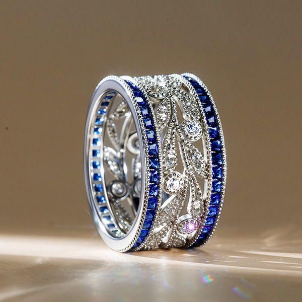 Round Cut White & Blue Sapphire Wedding Band in Sterling Silver