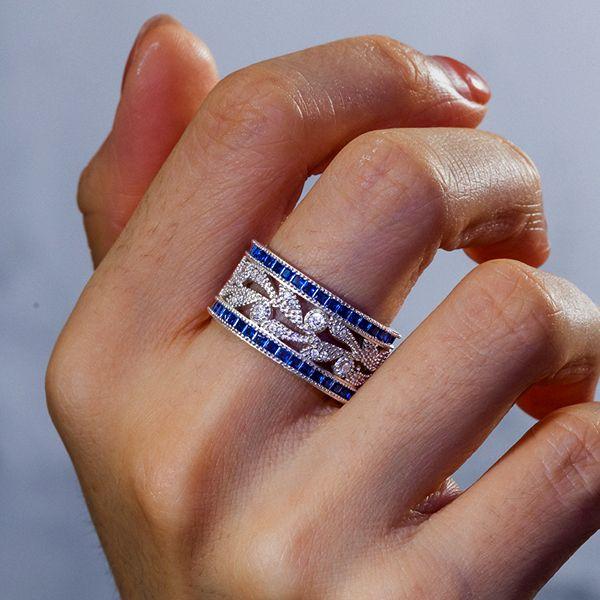 Round Cut White & Blue Sapphire Wedding Band in Sterling Silver
