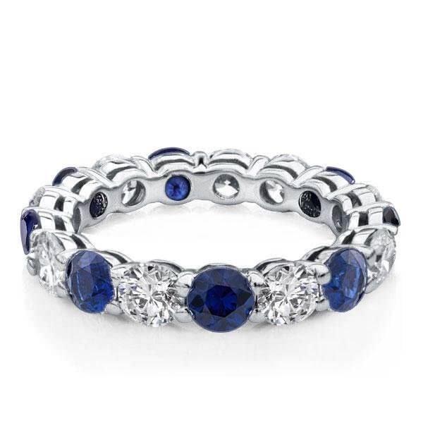 Round Cut Blue Sapphire Eternity Wedding Band in Rhodium Plated Sterling Silver