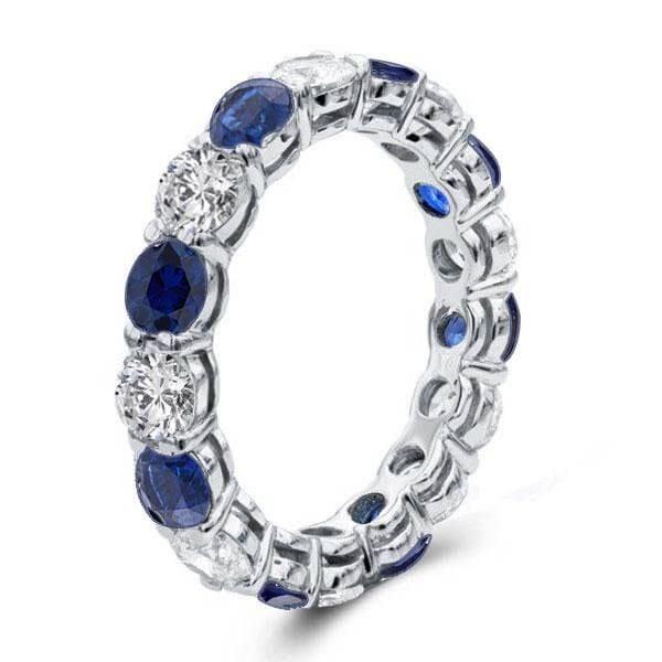 Round Cut Blue Sapphire Eternity Wedding Band in Rhodium Plated Sterling Silver