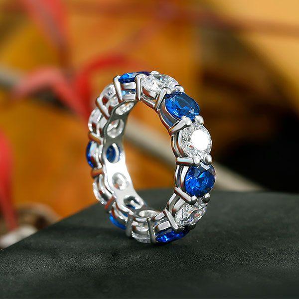 Round Cut Blue Sapphire Eternity Wedding Band in Rhodium Plated Sterling Silver