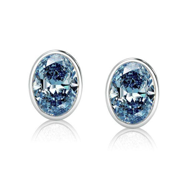 Oval Blue Topaz Stud Earrings in Sterling Silver Bezel Setting
