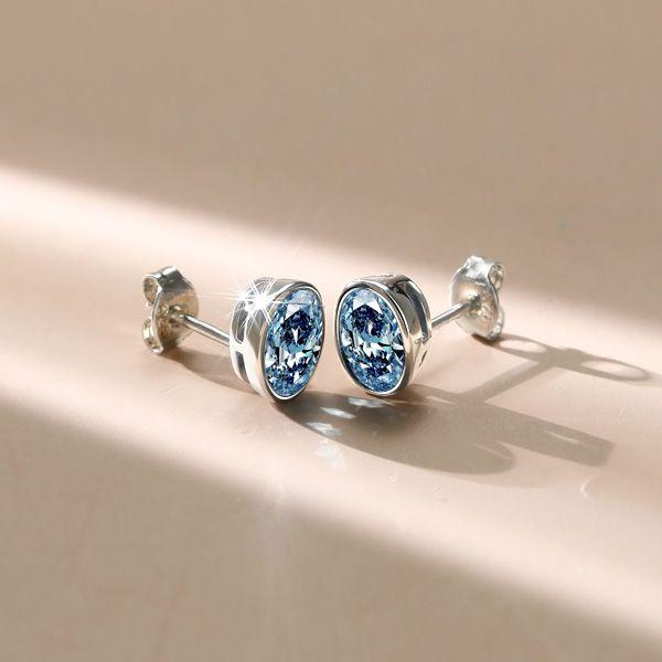Oval Blue Topaz Stud Earrings in Sterling Silver Bezel Setting