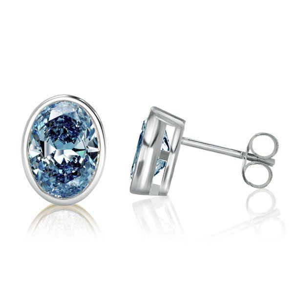 Oval Blue Topaz Stud Earrings in Sterling Silver Bezel Setting